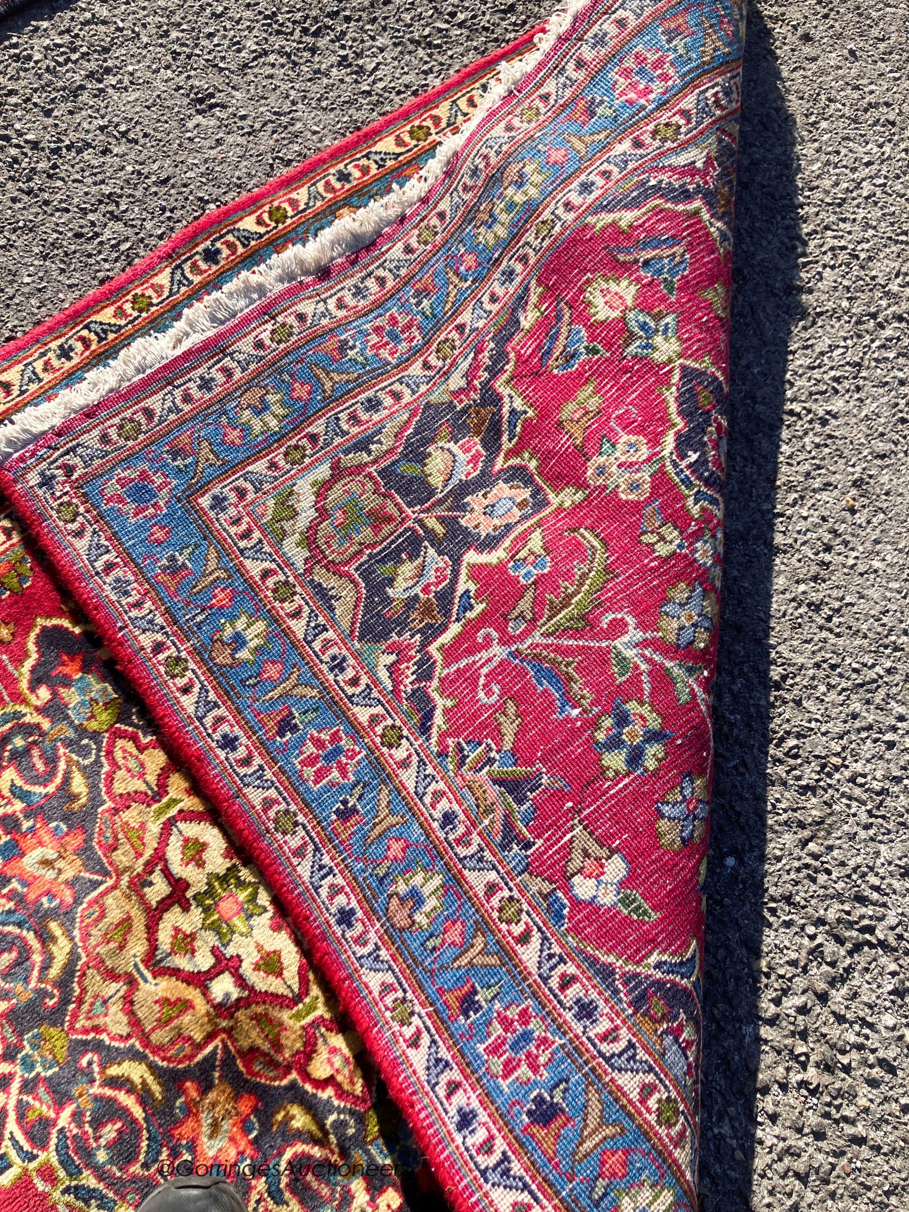 A Kashan claret ground rug, 186 x 93cm